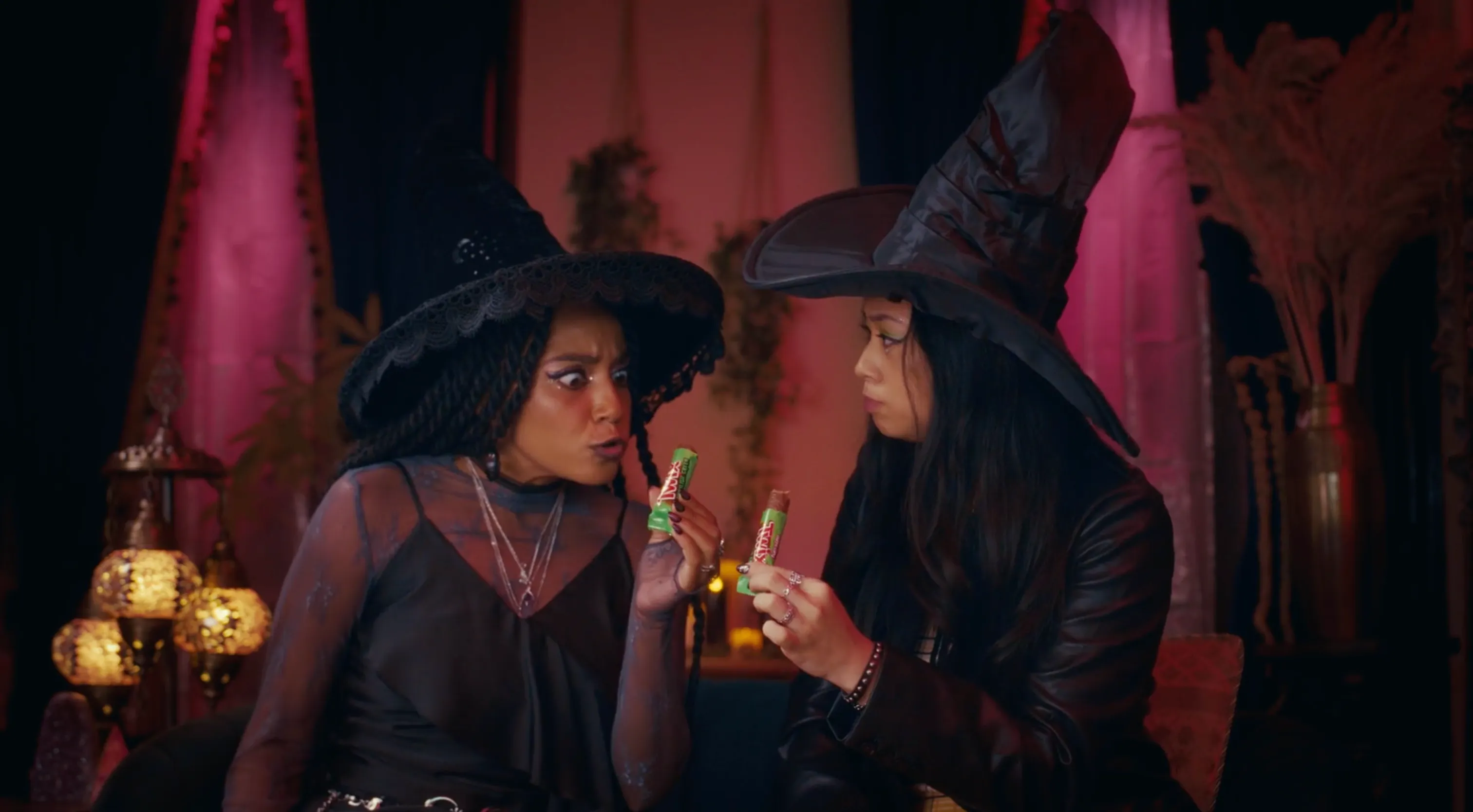 Two friends in witch makeup appear in a Twix advertisement